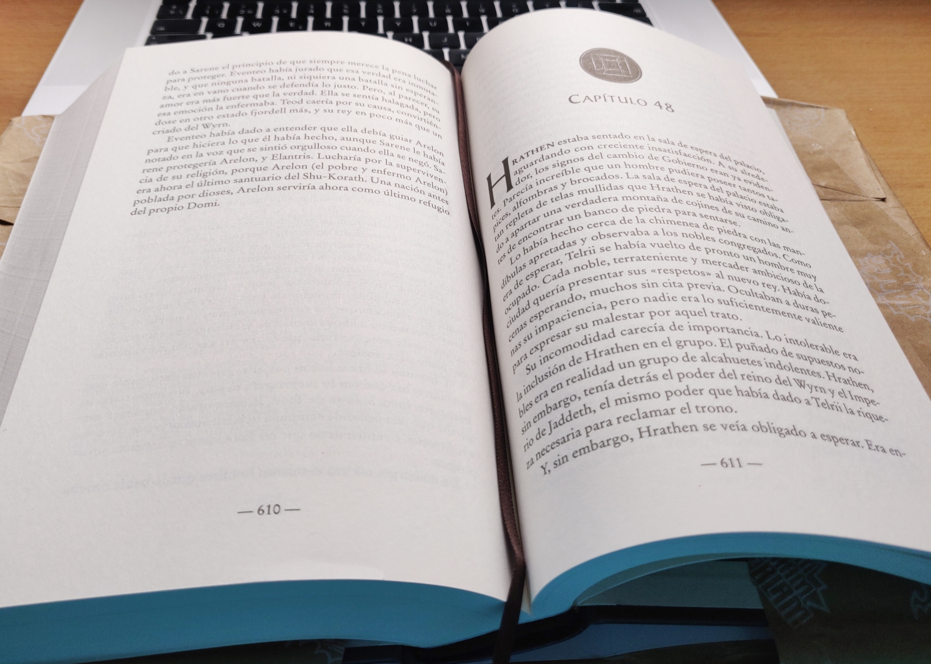 The Elantris book openend in page 610 over my laptop in my parent's house desktop